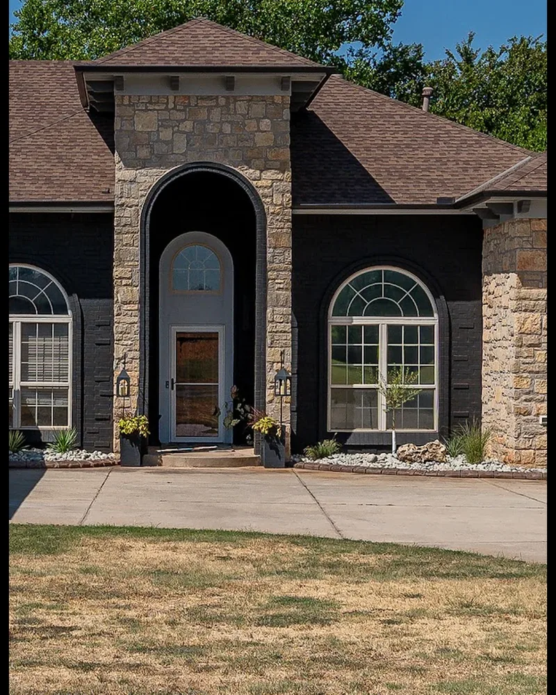 After: the same entry arch with the brick painted Celtic Stone charcoal black and the stone left natural